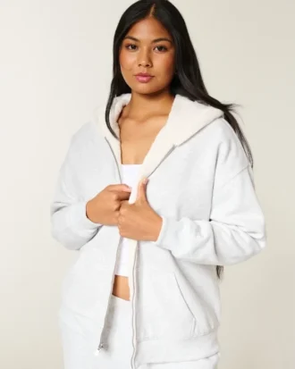 Käännettävä, tekoturkilla vuorattu fleece-huppari vetoketjulla