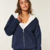 Käännettävä, tekoturkilla vuorattu fleece-huppari vetoketjulla Käännettävä, tekoturkilla vuorattu fleece-huppari vetoketjulla