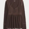 Pitkähihainen Henley-babydoll-toppi Pitkähihainen Henley-babydoll-toppi