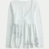 Pitkähihainen, rintamuksellinen graafinen babydoll-toppi Pitkähihainen, rintamuksellinen graafinen babydoll-toppi