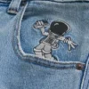 Vaaleat Astronaut Graphic Super Baggy -farkut Vaaleat Astronaut Graphic Super Baggy -farkut